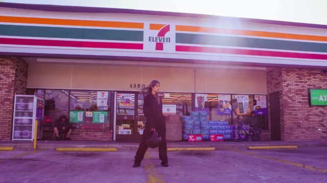 stylish woman standing in front of a convenience store
