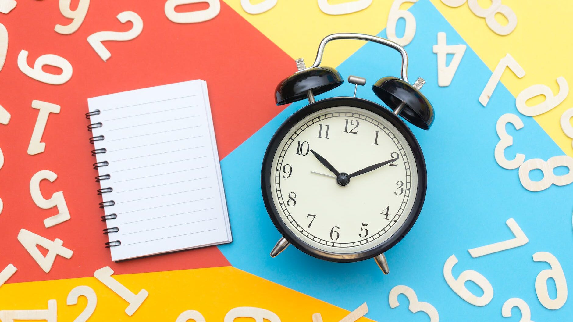 alarm clock lying on multicolored surface