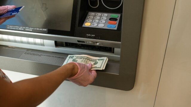 person deposits money on an atm